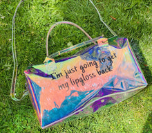 Load image into Gallery viewer, Iridescent &quot;Spend Da Night&quot; bag. A clear pvc bag is made of vinyl and has a zipper closure.
