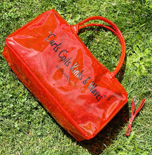 Load image into Gallery viewer, Red &quot;Spend Da Night&quot; bag. A clear pvc bag is made of vinyl and has a zipper closure.
